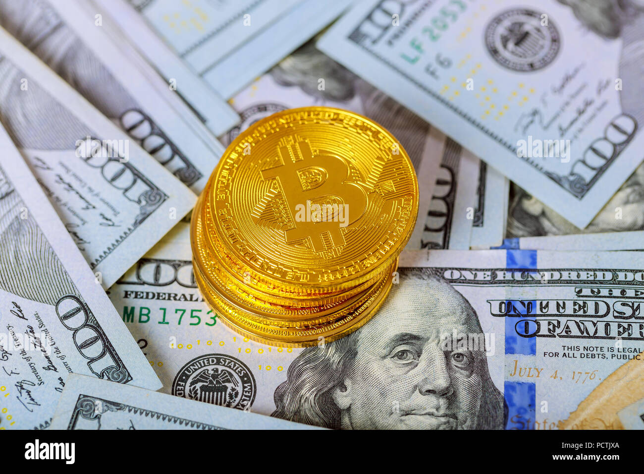 cryptocurrency and worldwide payment system golden bitcoin coin on us dollars close up. Electronic crypto currency Stock Photo