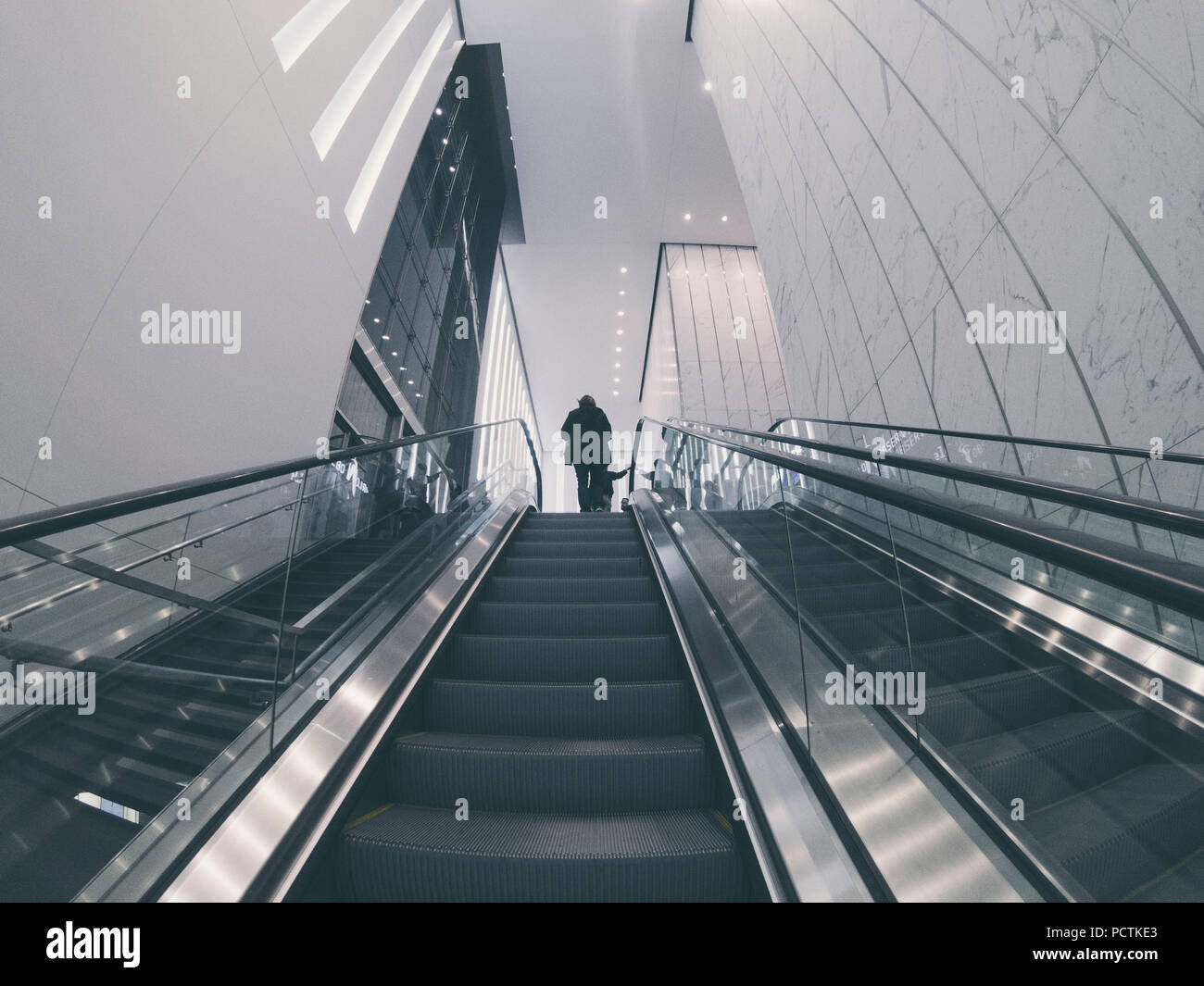 person on the end of a escalator on oculus station in nyc Stock Photo