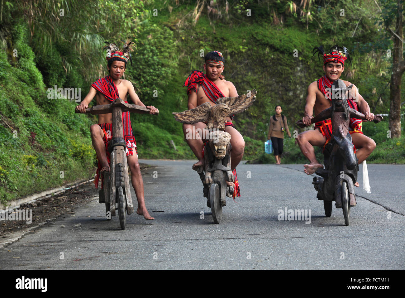 Ifugao tribesmen on wooden scooters and tricycle, Banaue, Ifugao,  Philippines, Asia Stock Photo