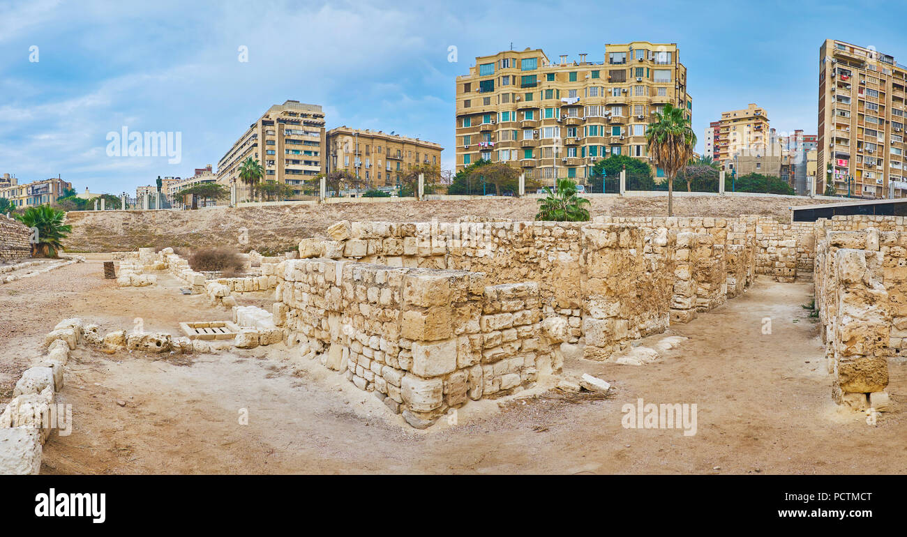 The street of ancient Roman village with ruined villas and modern residential buildings of Alexandria on background, Egypt. Stock Photo