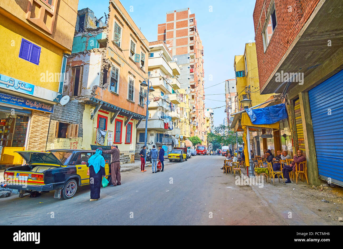 ALEXANDRIA, EGYPT - DECEMBER 18, 2017: The street of old and poor Karmouz district with old houses, unfinished buildings, neighboring with newly built Stock Photo