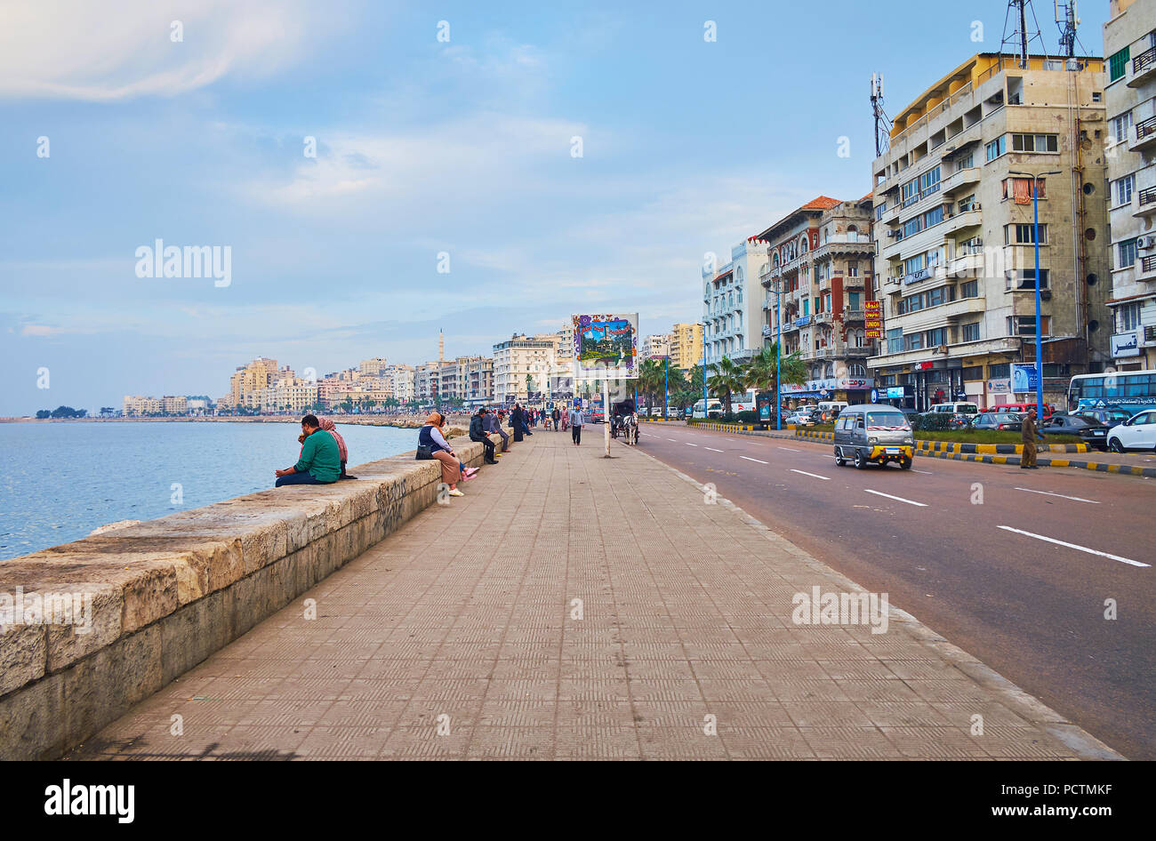 ALEXANDRIA, EGYPT - DECEMBER 18, 2017: The lazy walk in 26 of July Road (Corniche) - the central city street, stretching along the coast and famous as Stock Photo