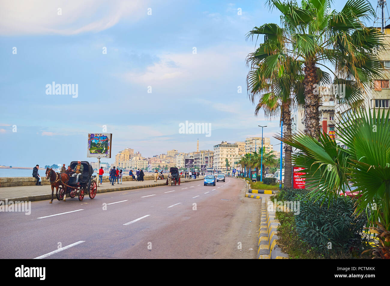 ALEXANDRIA, EGYPT - DECEMBER 18, 2017: The horse-drawn carriages offer joyful riding along the Corniche the central city street, stretching along the  Stock Photo