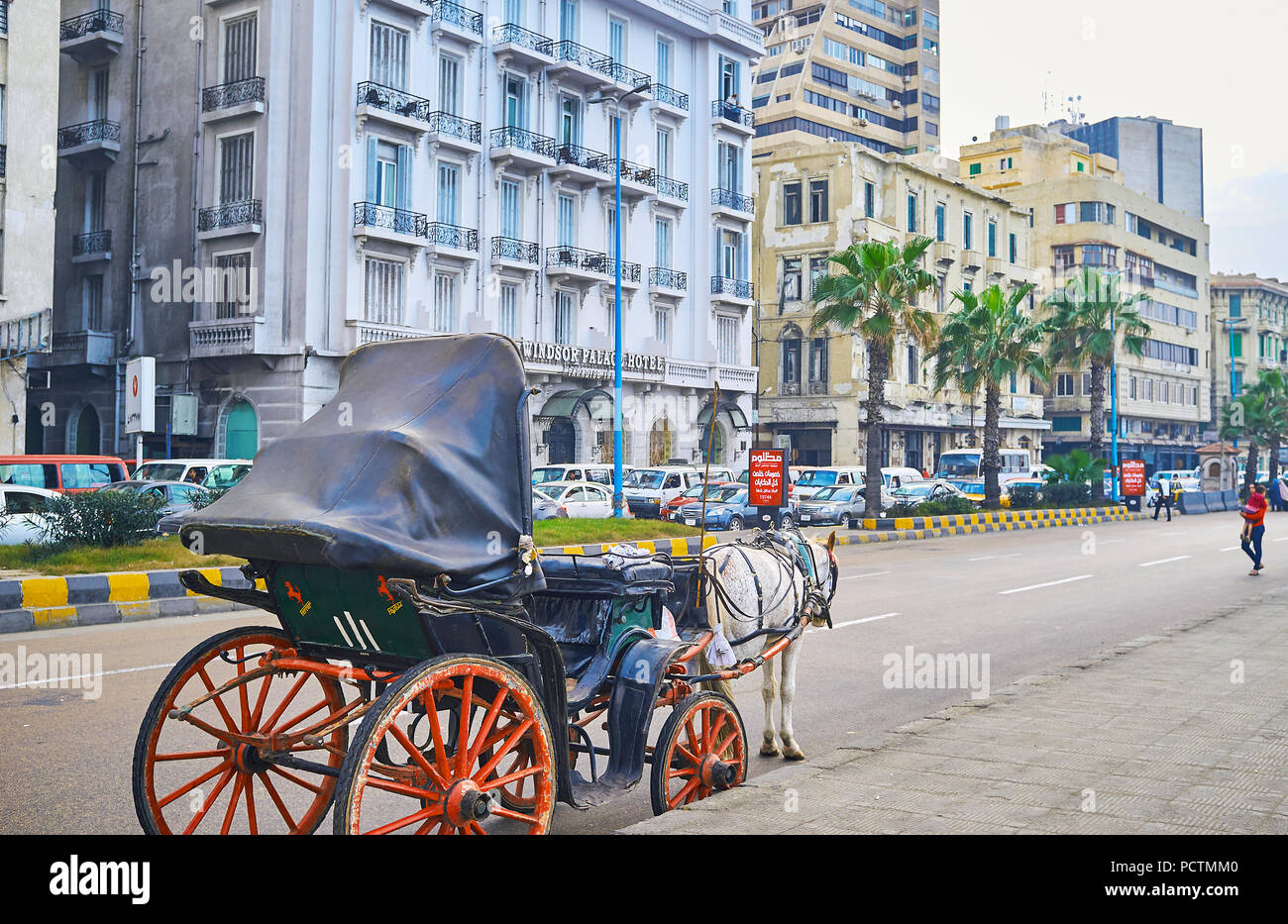 ALEXANDRIA, EGYPT - DECEMBER 18, 2017: The old-fashioned horse-drawn carriage are still popular tourist transport in city, the rides along Corniche Av Stock Photo