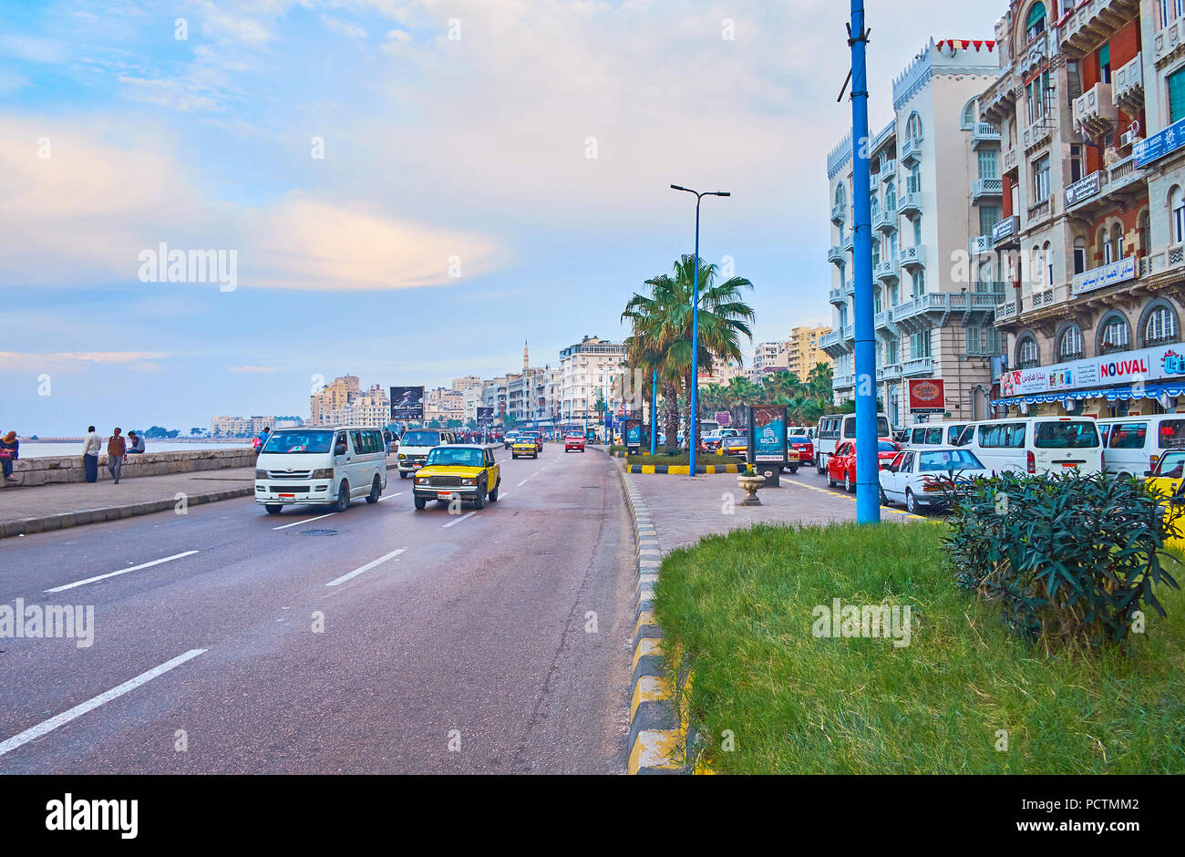 ALEXANDRIA, EGYPT - DECEMBER 18, 2017: The walk along the coast of Mediterranean sea in central city district, Corniche seaside promenade is busy plac Stock Photo