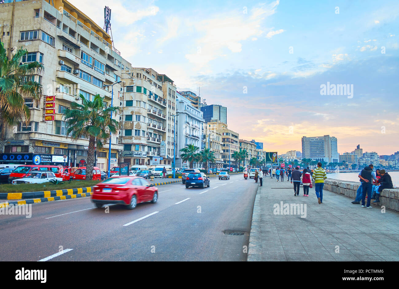 ALEXANDRIA, EGYPT - DECEMBER 18, 2017: Walk along 26 of July Road (Corniche), the most popular promenade of the city with historic mansions, old hotel Stock Photo