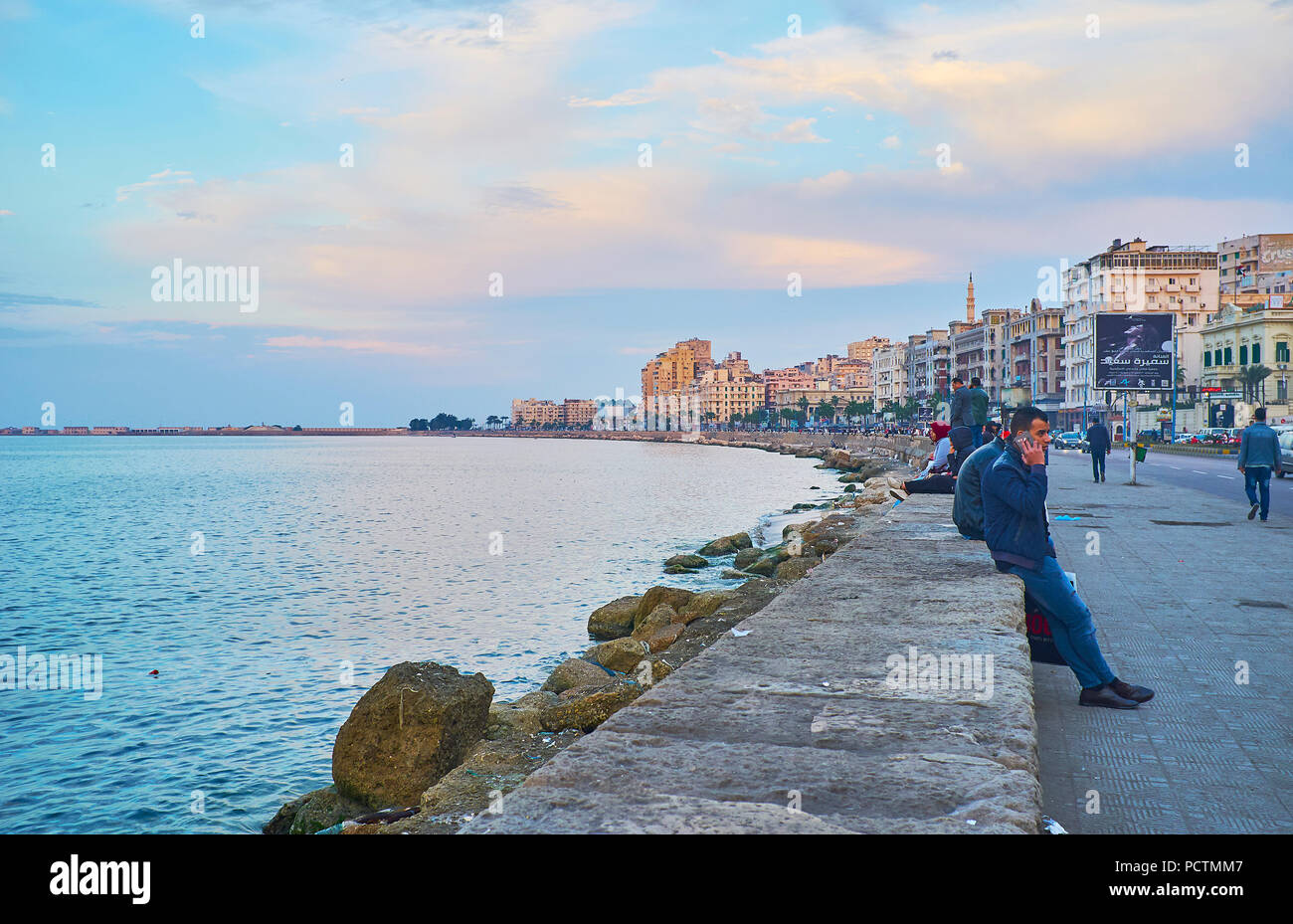 ALEXANDRIA, EGYPT - DECEMBER 18, 2017: The evening is nice time for a family walk of meet with friends in Corniche seaside promenade - the joyful plac Stock Photo