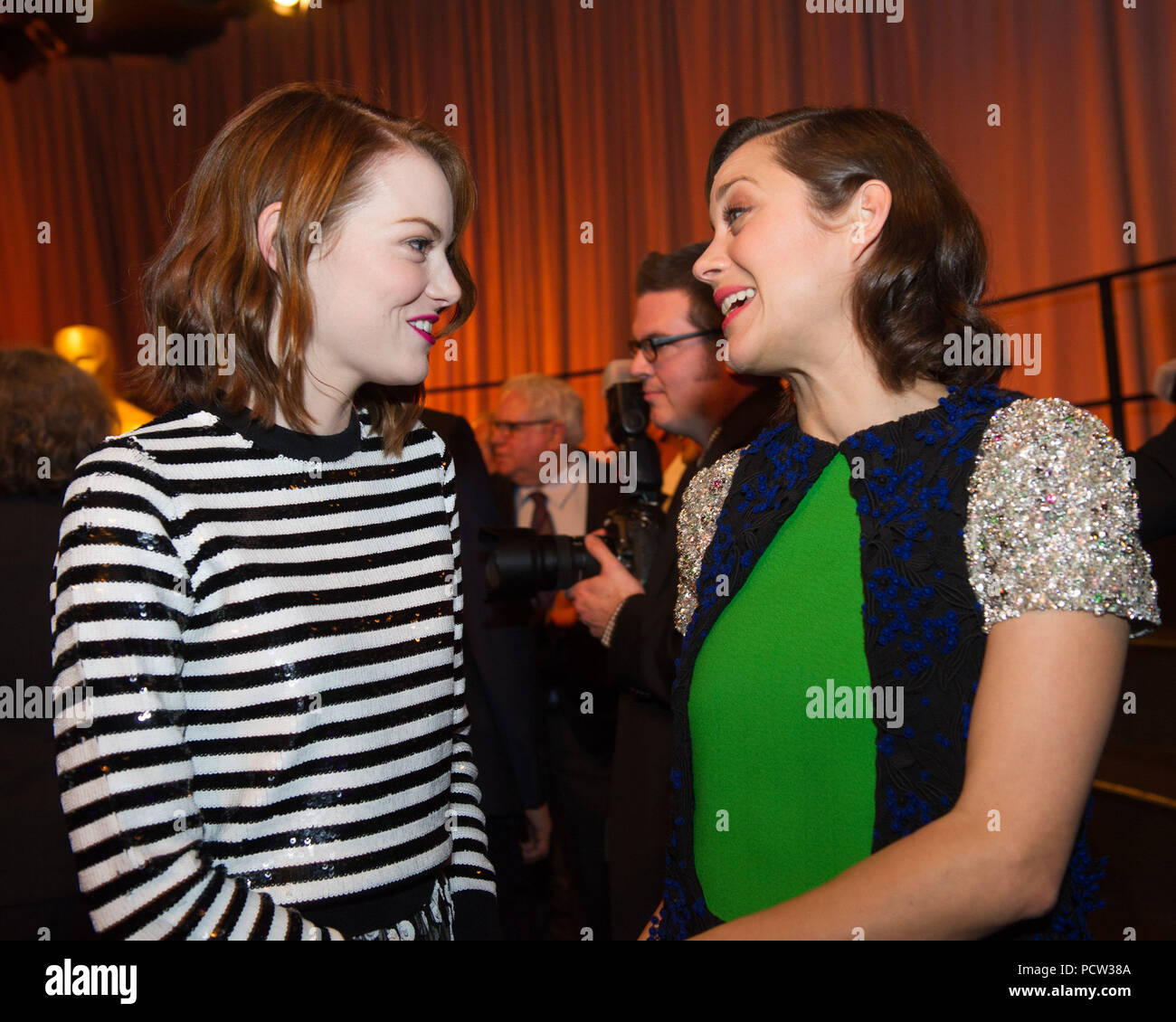 HOLLYWOOD, CA - FEBRUARY 02: Nominees Luncheon at the Beverly Hilton, February 2, 2015 for the 87th Oscars for outstanding film achievements of 2014 which will be presented on Sunday, February 22, 2015, at the Dolby Theatre and televised live by the ABC Television Network on February 22, 2015 in Hollywood, California.    People:  Emma Stone, Marion Cotillard Stock Photo