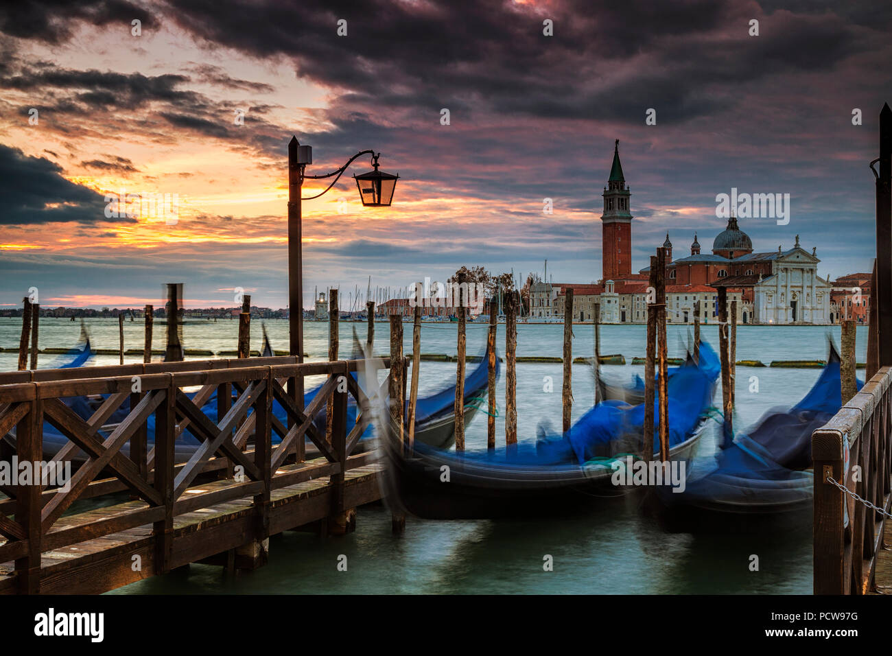 Parked gondolas in Venice with the island of San Giorgio Maggiore in the background Stock Photo