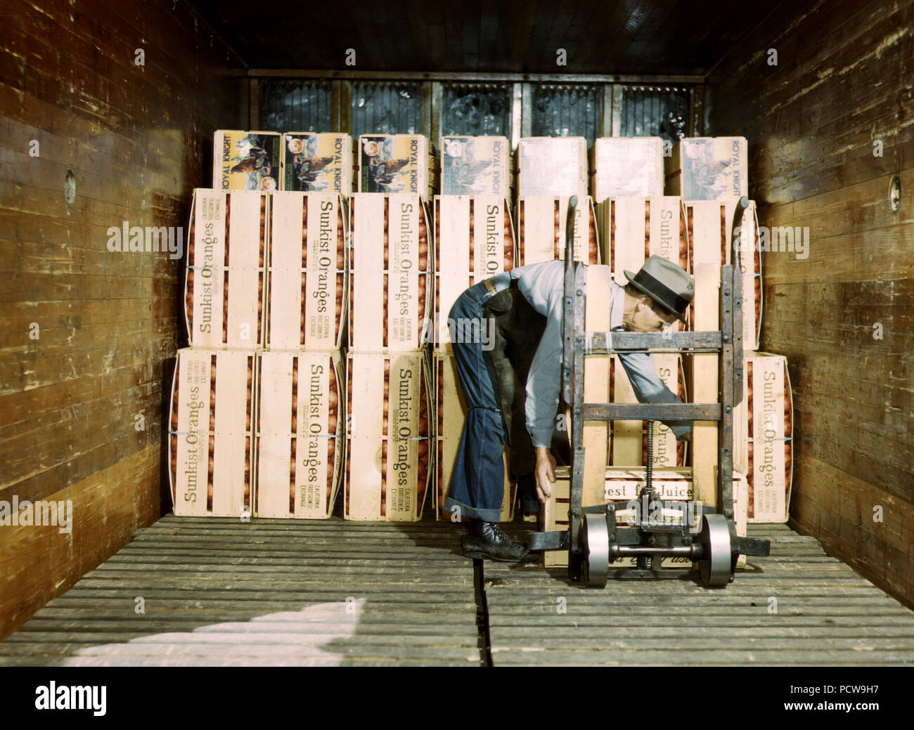 Loading oranges into a refrigerator car at a co-op orange packing plant, Redlands, Calif. March 1943 Stock Photo