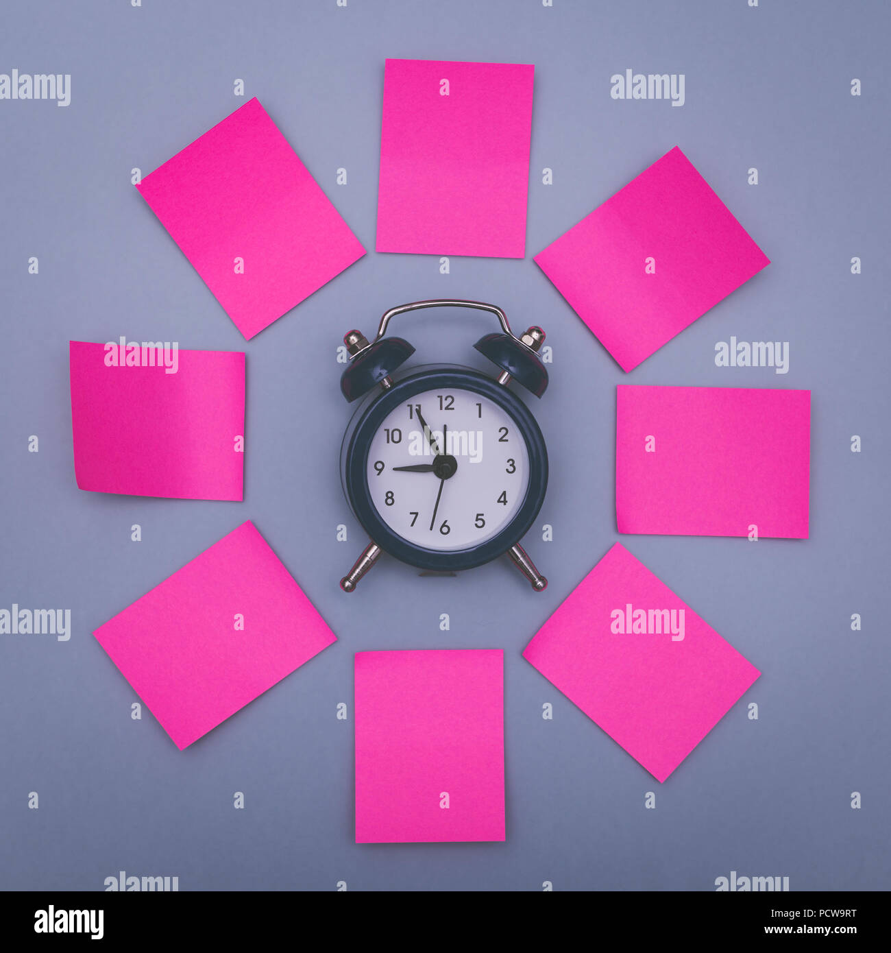 Pink sticky notes and clock, memory concept background. Stock Photo