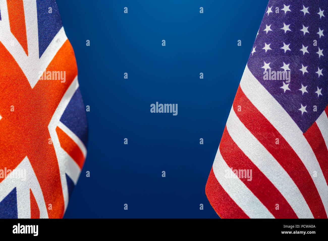 Flags United State of America and Great Britain with blue background. Concept of international relations. Stock Photo
