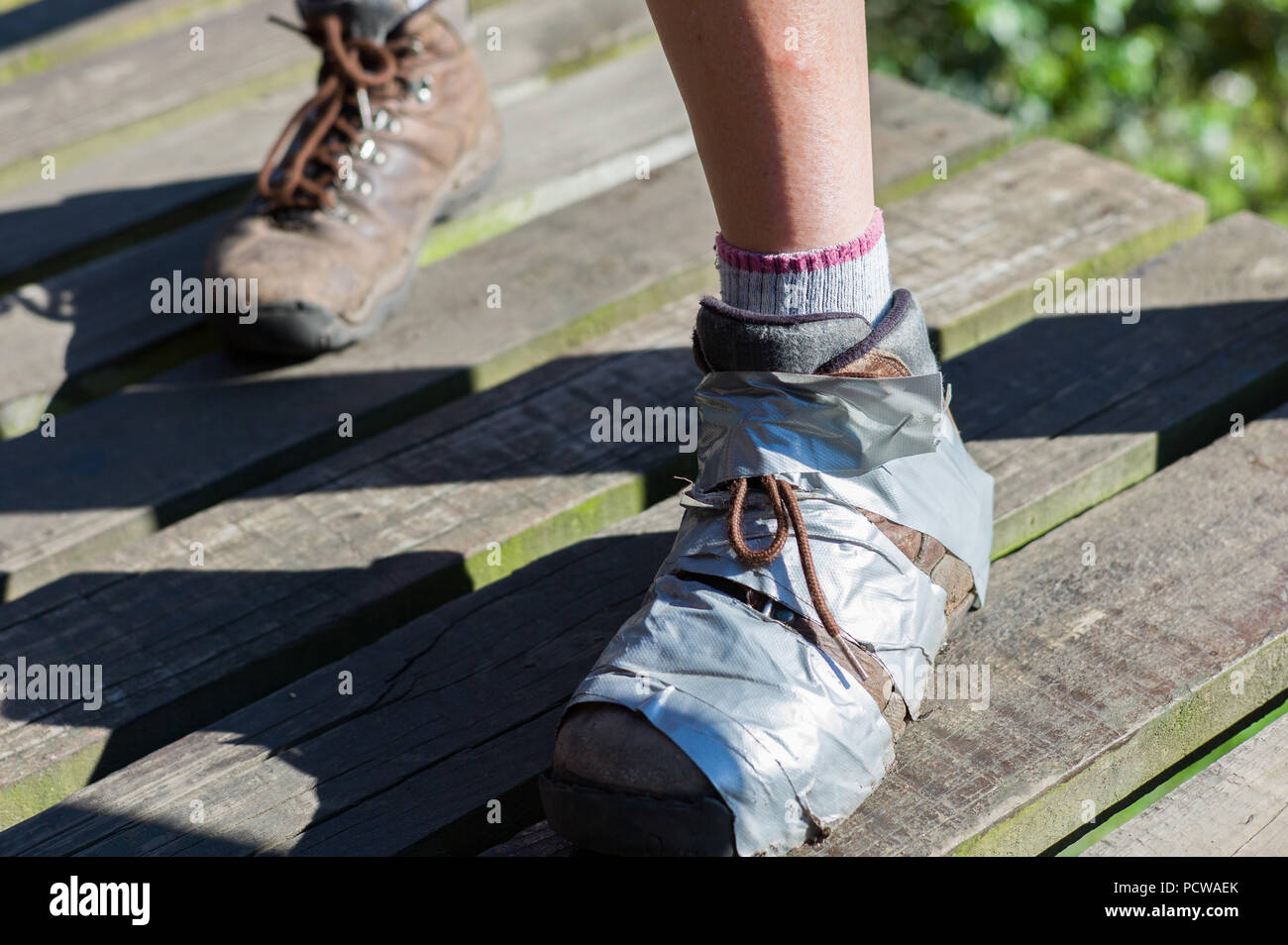 Hiking boot taped together with duct tape, Tsitsikamma Hiking Trail, Tsitsikamma Mountains, Eastern Cape Province, South Africa. Stock Photo