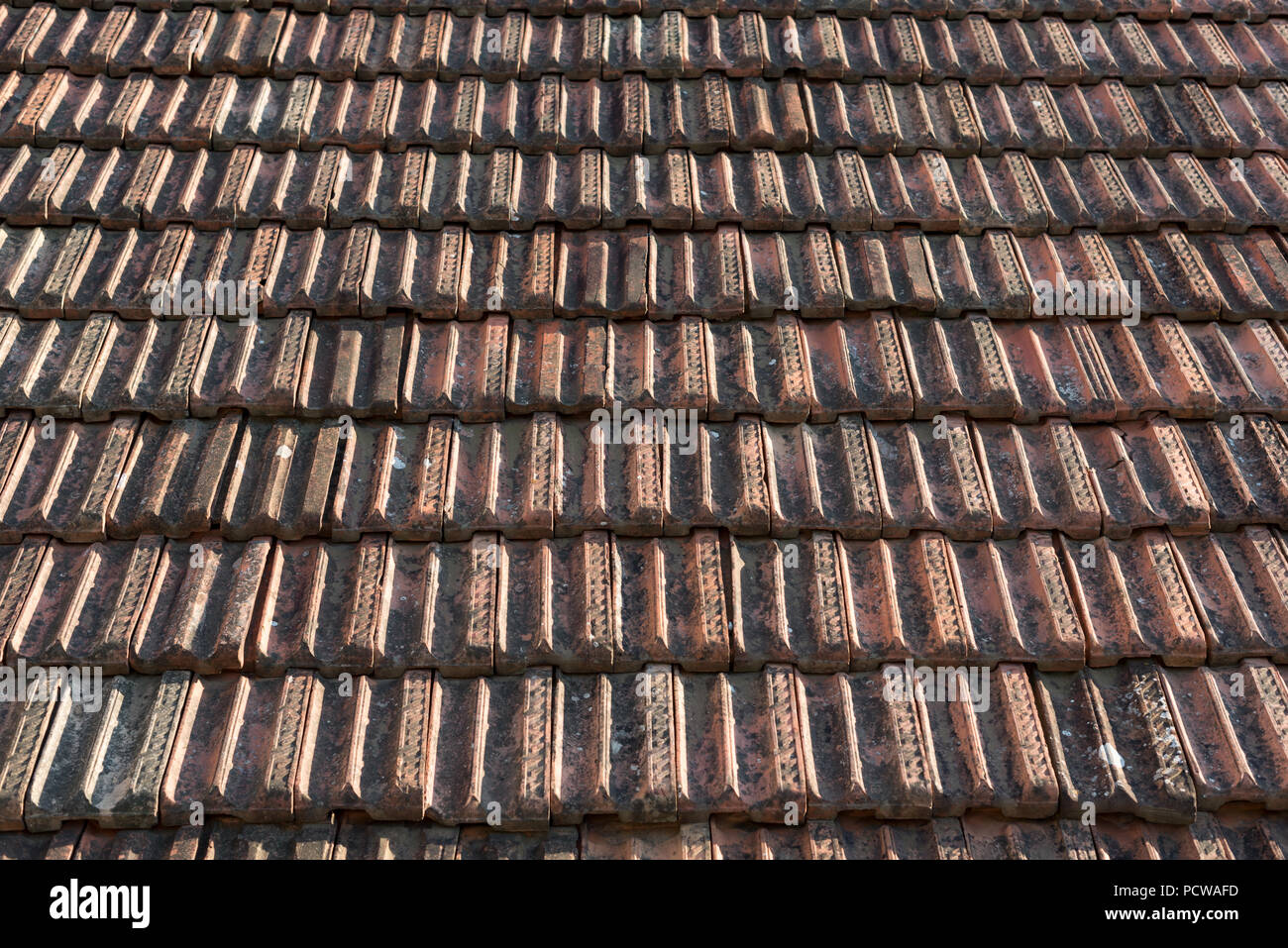 Old red roof tiles as background, wallpaper Stock Photo