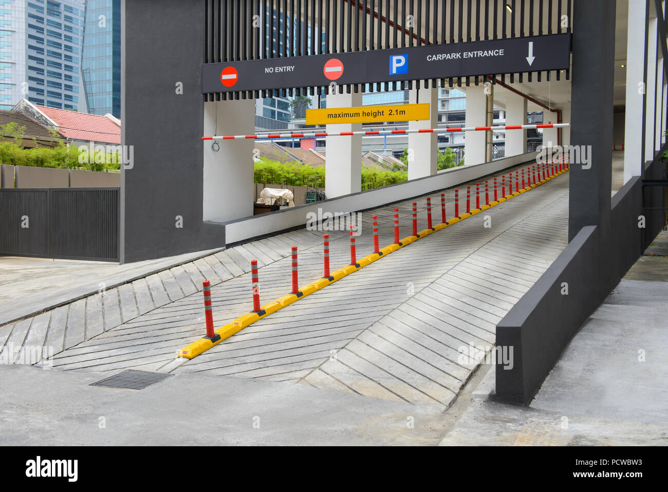 The entrance to car park ramp slope way on front of building Stock Photo -  Alamy
