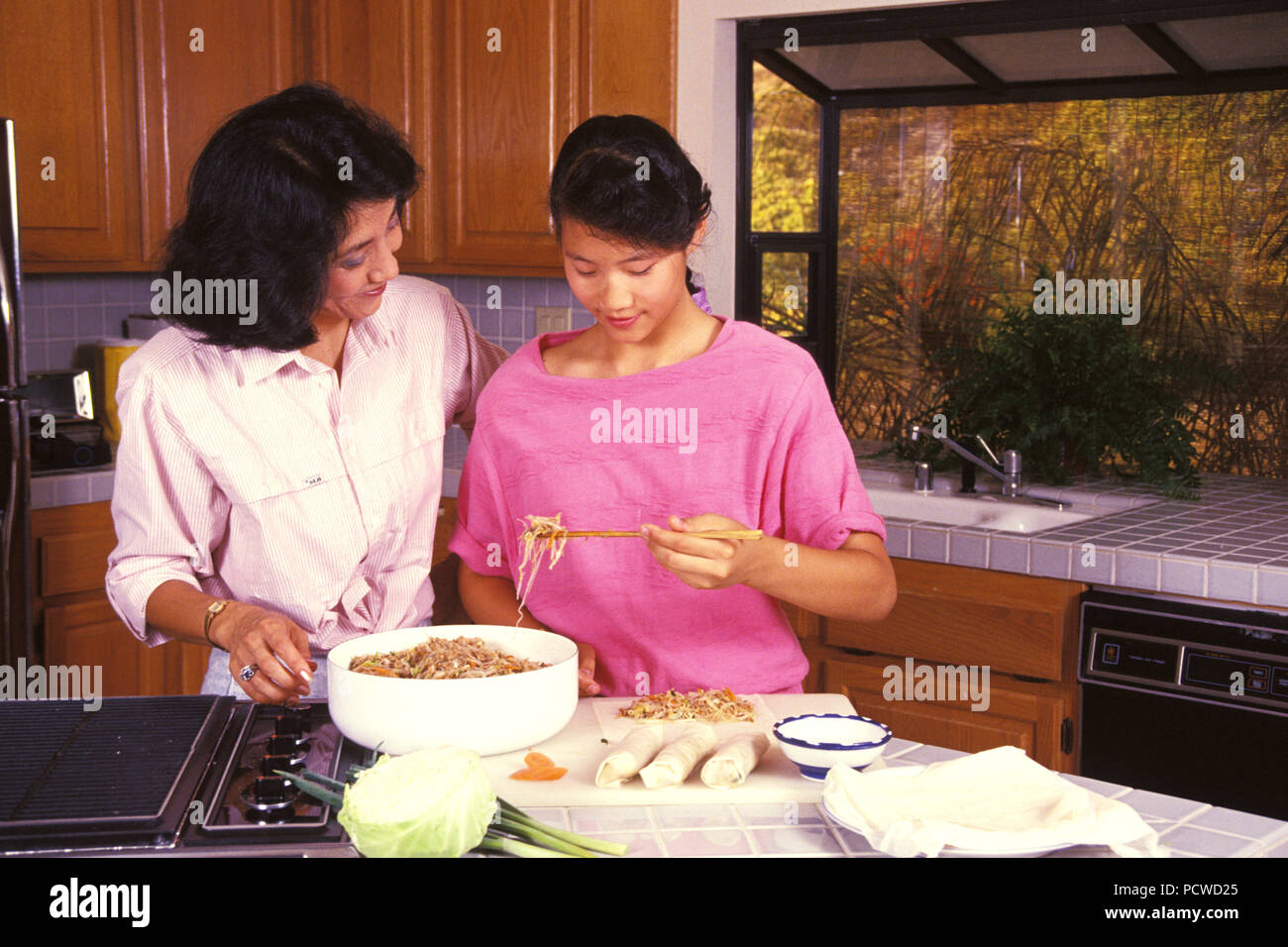 Chinese mother and daughter learning to make spring rolls  © Myrleen Pearson  ....Ferguson Cate Stock Photo