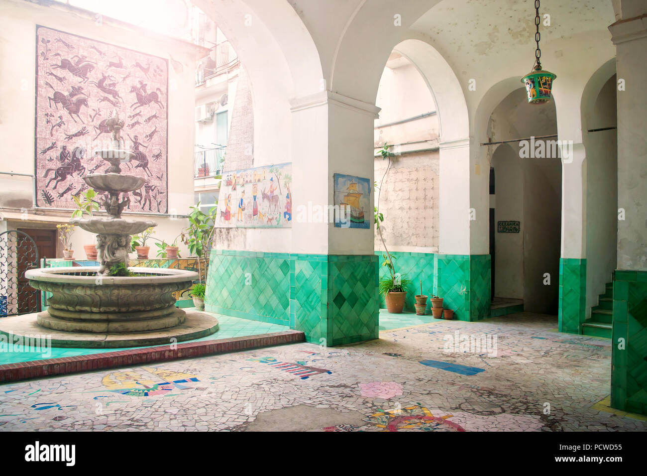 inner part of residential building with fountain decorated with ceramics in traditional Italian style in Vietri Sul Mare, Campania, Italy Stock Photo