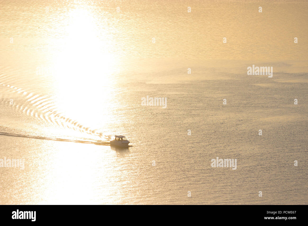 small boat in the river in sunset light Stock Photo - Alamy