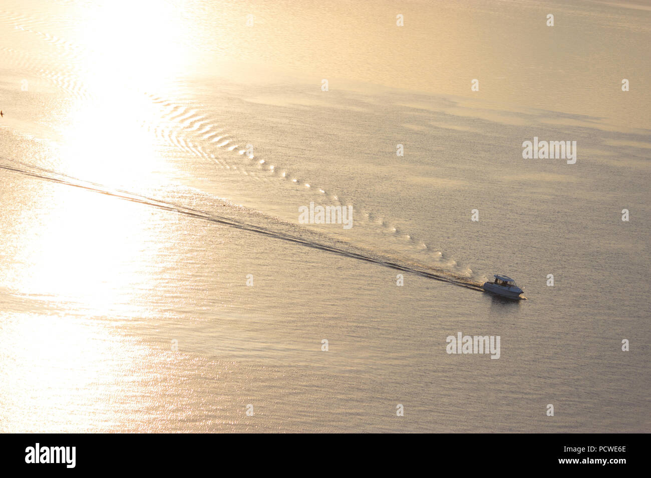 small boat in the river in sunset light Stock Photo - Alamy