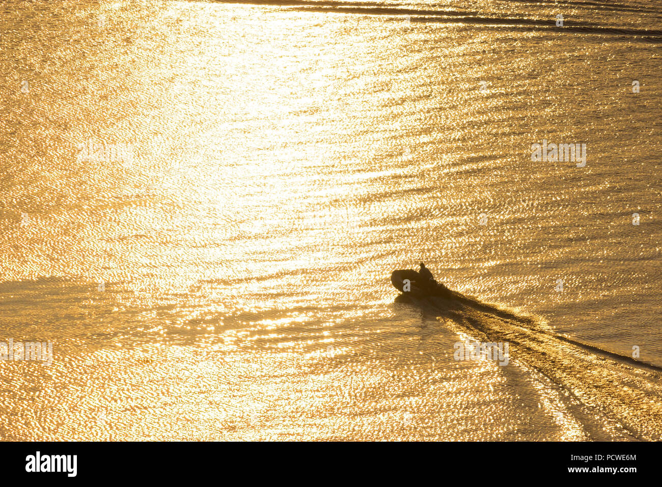 small boat in the river in sunset light Stock Photo - Alamy