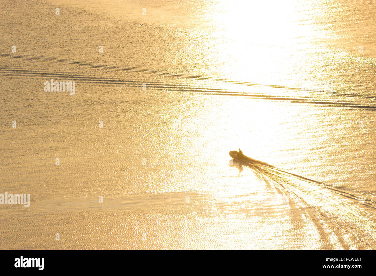 small boat in the river in sunset light Stock Photo - Alamy