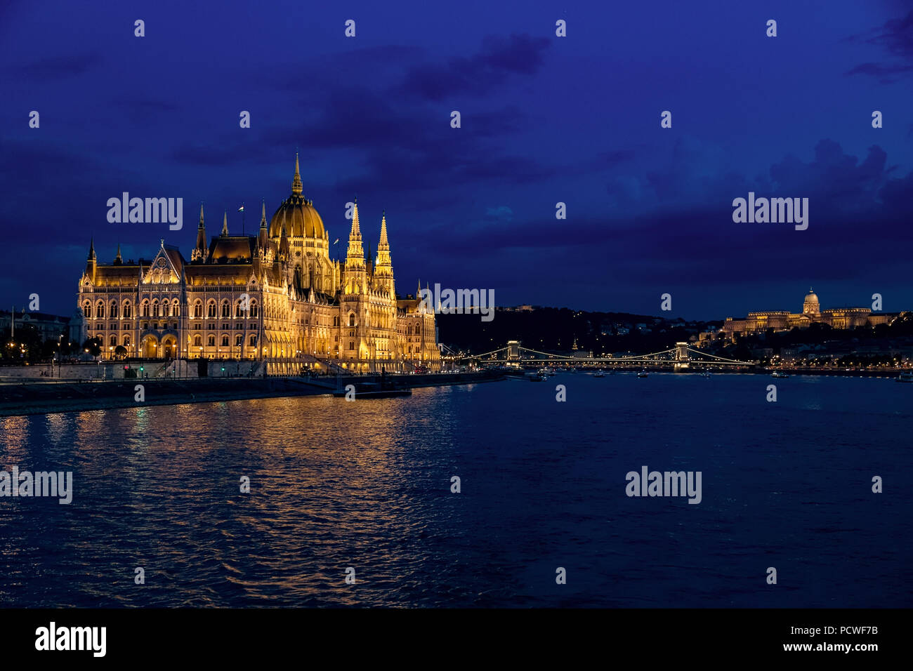 Night view of Budapest city. Parliament building on left, Buda Castle Hill on right and the Chain Bridge in middle. Stock Photo
