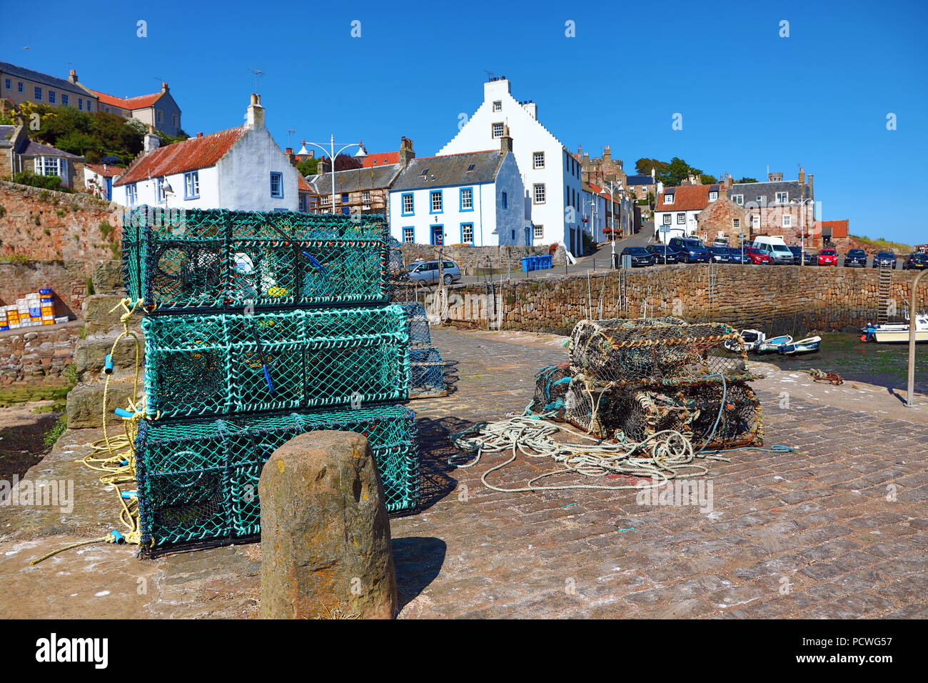 Lobster pots on the quay at Crail fishing village and harbour, Fife, Scotland Stock Photo