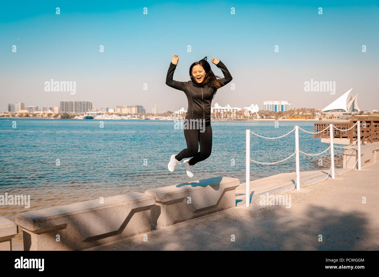 A young happy woman jumps in the air,received a good news or a winner. Stock Photo
