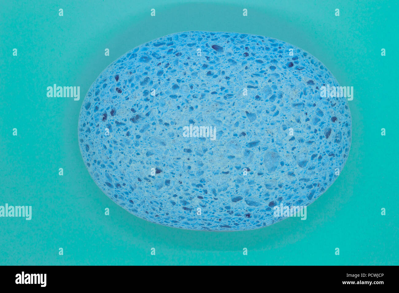 Abstract composition of blue sponge on blue background surface Stock Photo