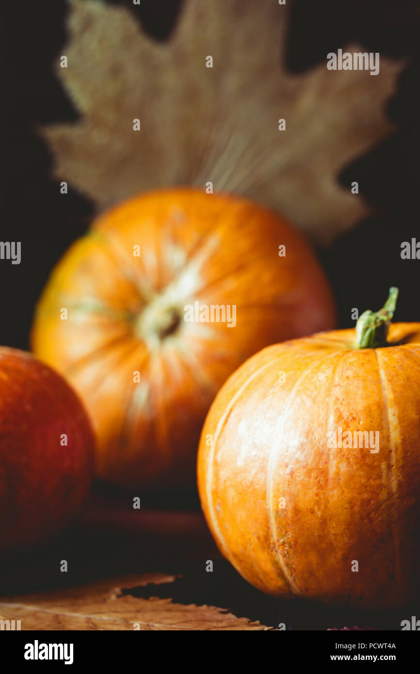 Small pumpkins and dried fall leaves still life. Autumn background ...