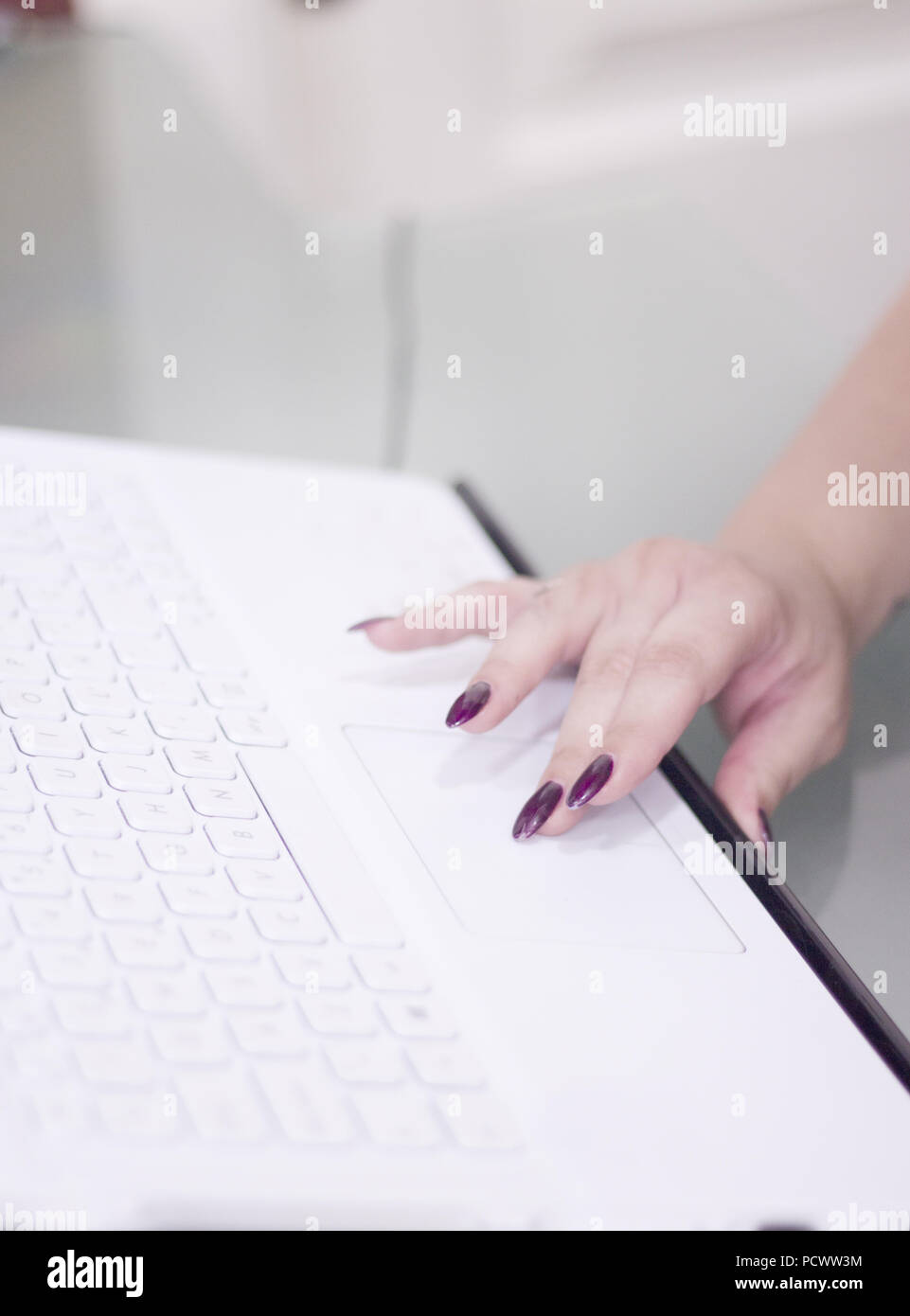Womans hand on white computer keyboard. Copy space Stock Photo