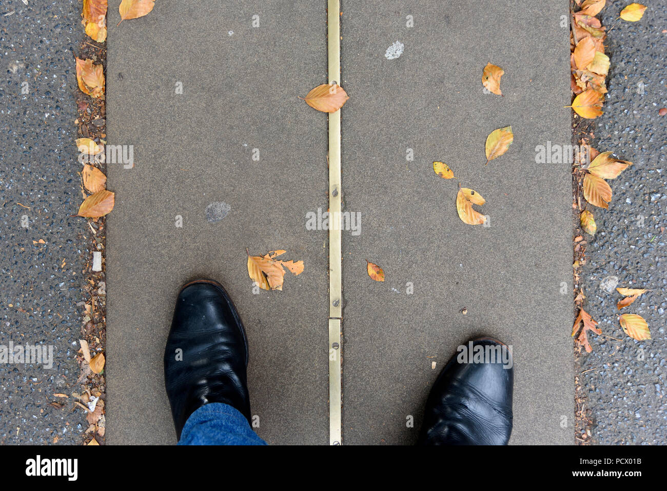 12-10-2017 London, UK. Feet either side of the Greenwich Meridian Line.  Photo: © Simon Grosset Stock Photo