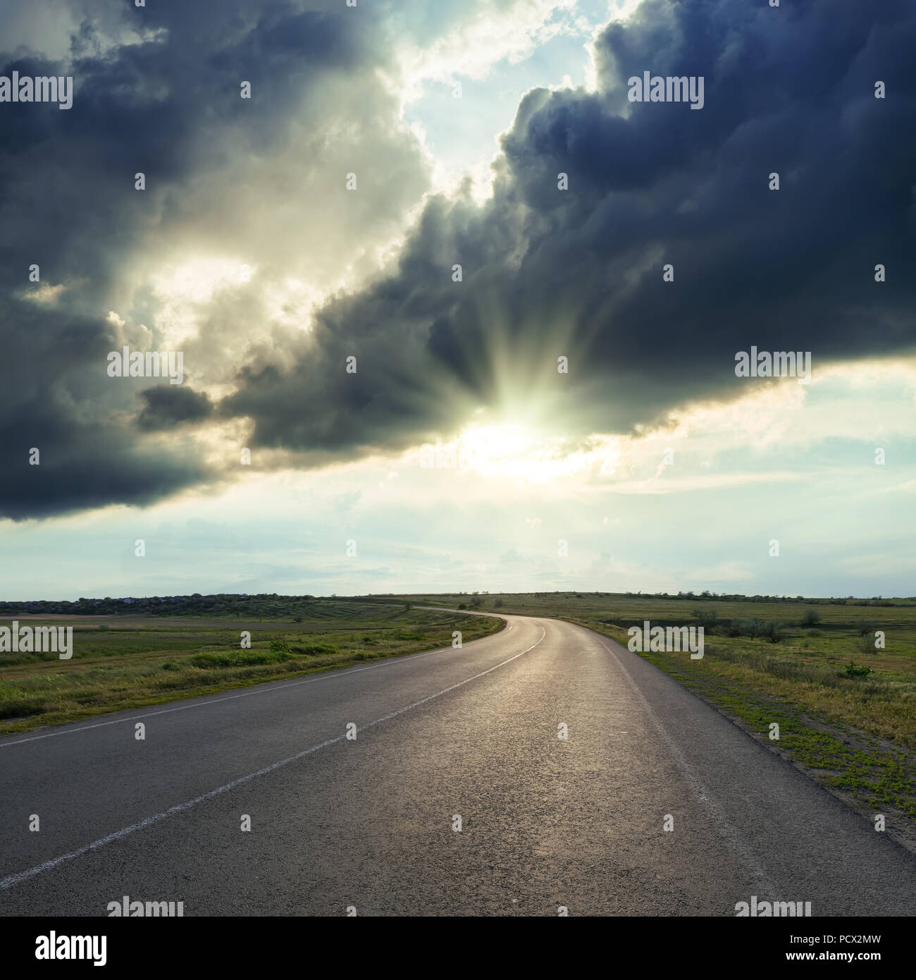dramatic clouds in sunset over asphalt road Stock Photo - Alamy