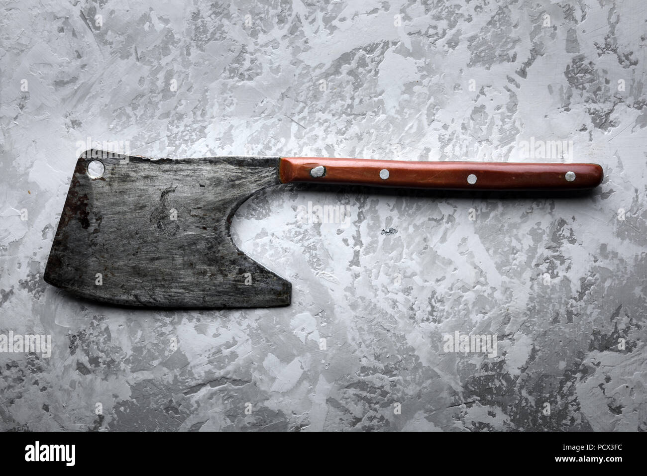 Old rustic axe for meat on grunge background Stock Photo