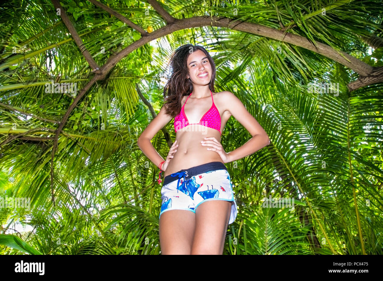Girl in bikini  with jungle leaves behind at Maldives island Olhuveli. Stock Photo