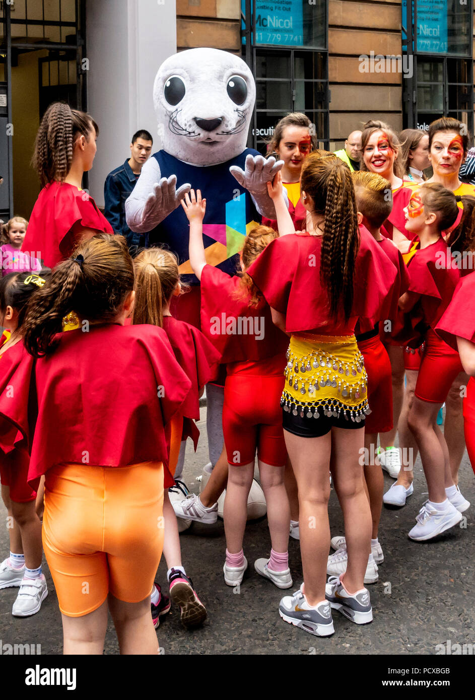 Glasgow, Scotland, UK. 04th August 2018. Bonnie the Seal, Mascot of the European Championships, Glasgow 2018, meeting and greeting children about to take part in the Merchant City Festival Parade. The parade was part of Festival 2018, which is running in the city in parallel with the sports event. Credit: Elizabeth Leyden/Alamy Live News Stock Photo