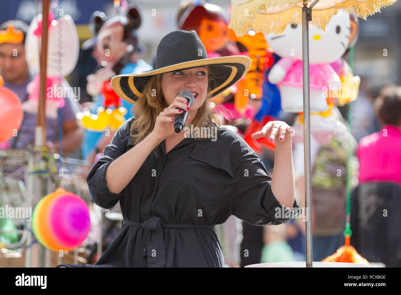 Stockton-on-Tees, UK. Saturday, 4th August, 2018. A street performer from Delinus sings jazz songs at 'Chez Jopie',  a unique mobile cafe, at the 31st Stockton International Riverside Festival. Credit: Andrew Nicholson/Alamy Live News Stock Photo