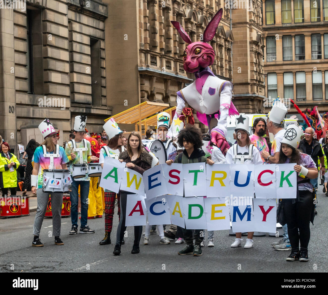 Glasgow, Scotland, UK. 04th August 2018. Young people from Awestruck Academy, a Creative Arts Centre in Clydebank, waiting for the start of the Carnival Procession of the Merchant City Festival. The festival is part of Festival 2018 a city-wide cultural event running in parallel with Glasgow 2018, the European Championships. Credit: Elizabeth Leyden/Alamy Live News Stock Photo
