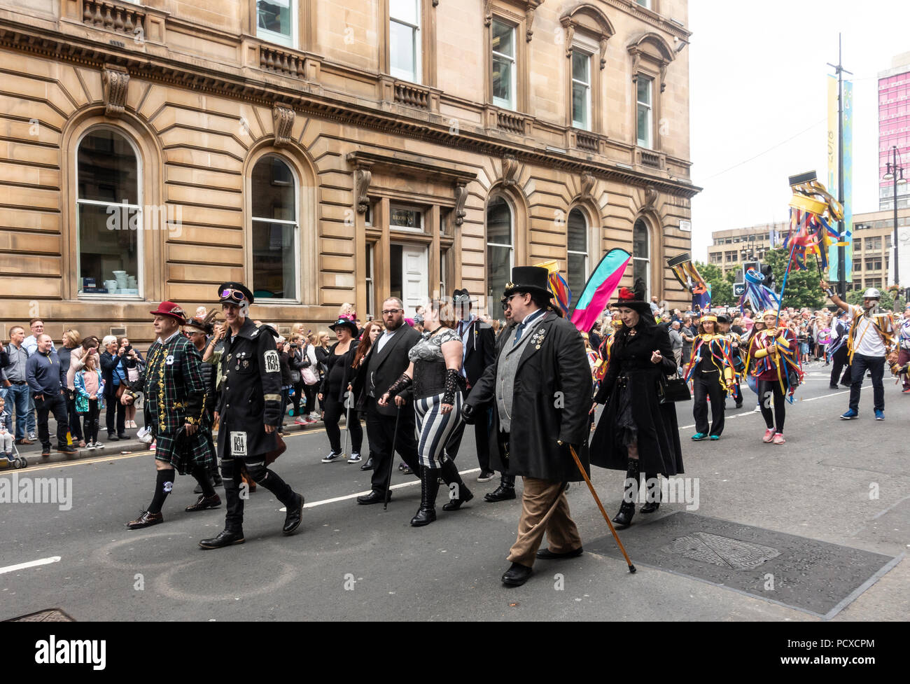 Glasgow, Scotland, UK. 04th August 2018. Adults dressed in Steampunk fashion and children in carvinal clothing, all participants in the Carnival Procession of the Merchant City Festival. The festival is part of Festival 2018 a city-wide cultural event running in parallel with Glasgow 2018, the European Championships. Credit: Elizabeth Leyden/Alamy Live News Stock Photo