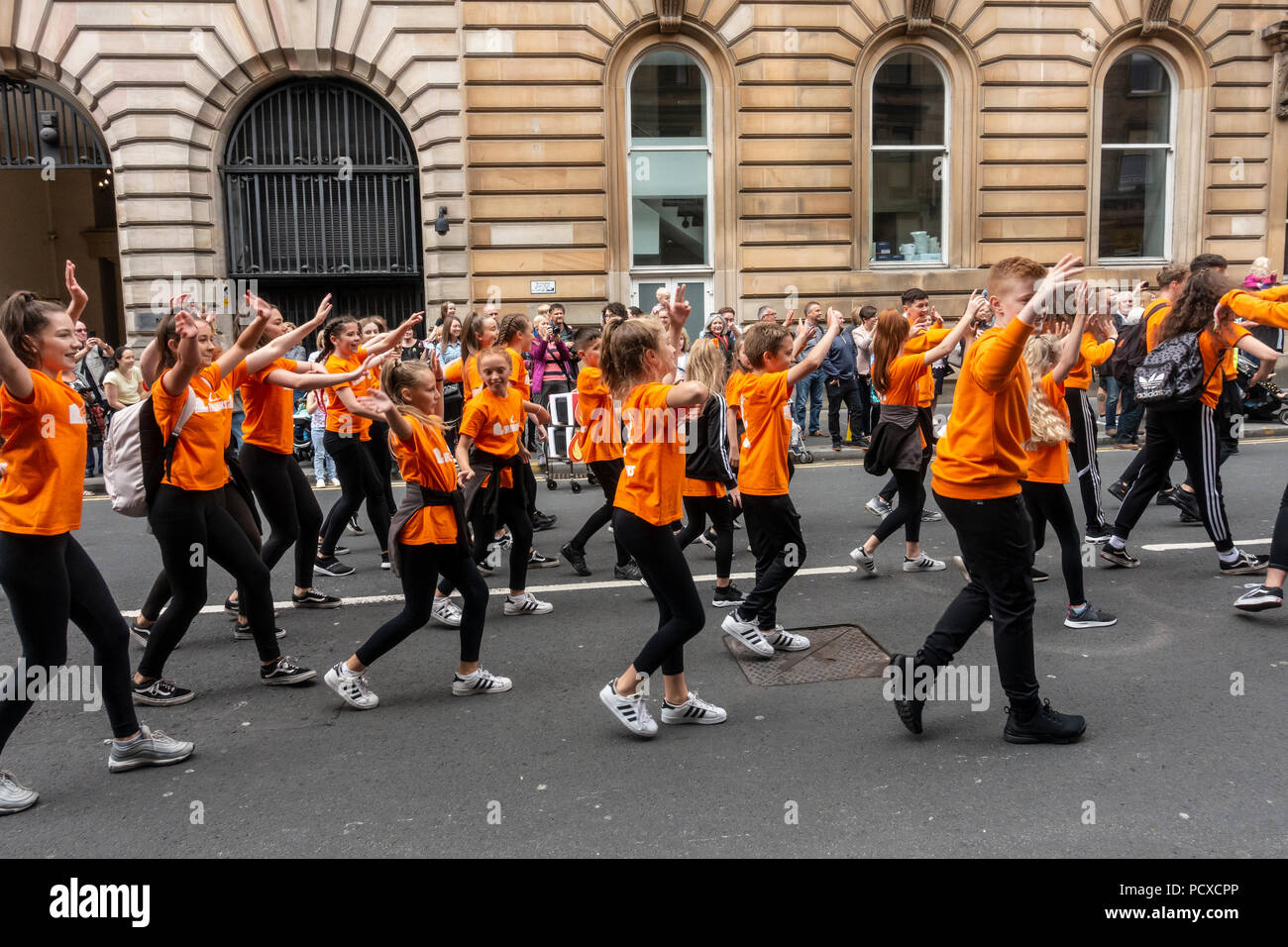 Glasgow, Scotland, UK. 04th August 2018. Young dancers from Urbaniks street dance school in Milngavie dancing backwards in Merchant City. They were participating in the Carnival Procession of the Merchant City Festival. The festival is part of Festival 2018 a city-wide cultural event running in parallel with Glasgow 2018, the European Championships. Credit: Elizabeth Leyden/Alamy Live News Stock Photo