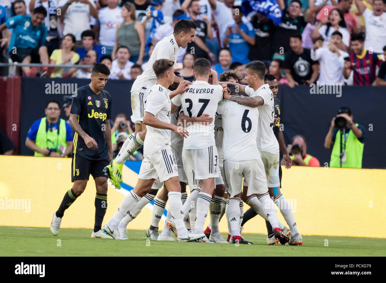 Maryland, USA. 4 August 2018. Real Madrid players celebrate a goal by Real  Madrid midfielder Marco Asensio (20) during an International Champions Cup  match between Real Madrid vs Juventus at FedExField in