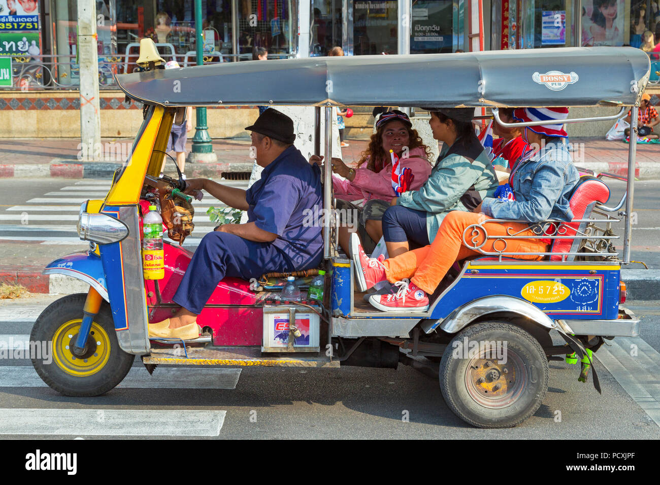 Thai tuk-tuk and passengers, Bangkok, Thailand Stock Photo