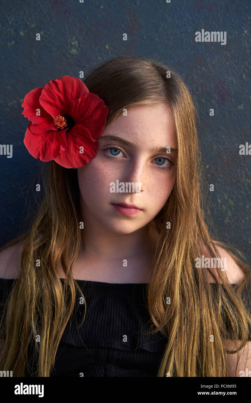 Blond kid girl portrait with hibiscus red flower on hair Stock Photo ...