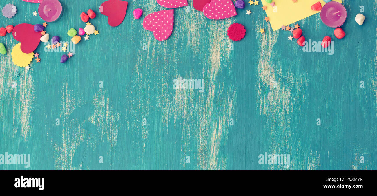 Banner Festive confetti background heart candy color saturated. Wood old blue background with copy space flat lay Stock Photo