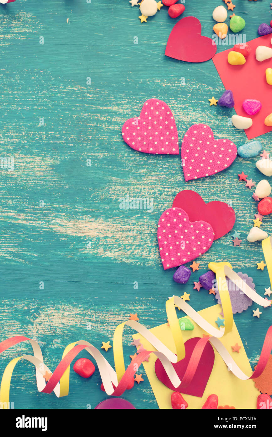 Festive confetti background heart candy color saturated. Wood old blue background with copy space flat lay Stock Photo