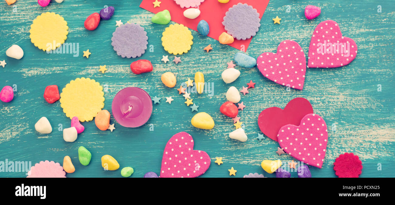 Banner Festive confetti background heart candy color saturated. Wood old blue background with copy space flat lay Stock Photo