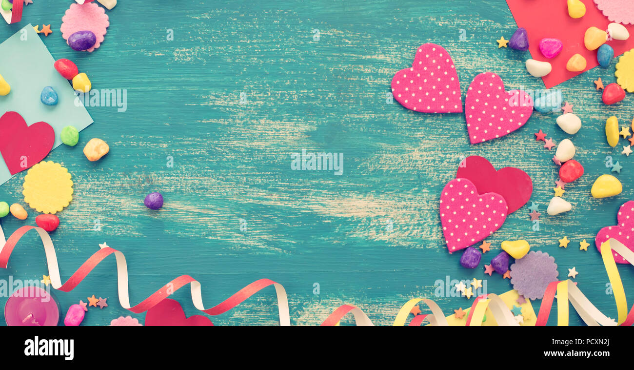 Banner Festive confetti background heart candy color saturated. Wood old blue background with copy space flat lay Stock Photo