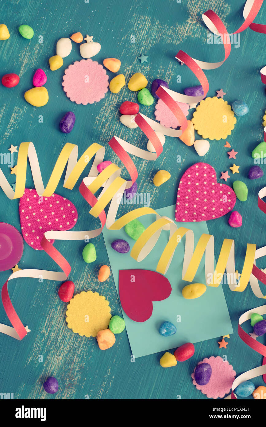 Festive confetti background heart candy color saturated. Wood old blue background with copy space flat lay Stock Photo