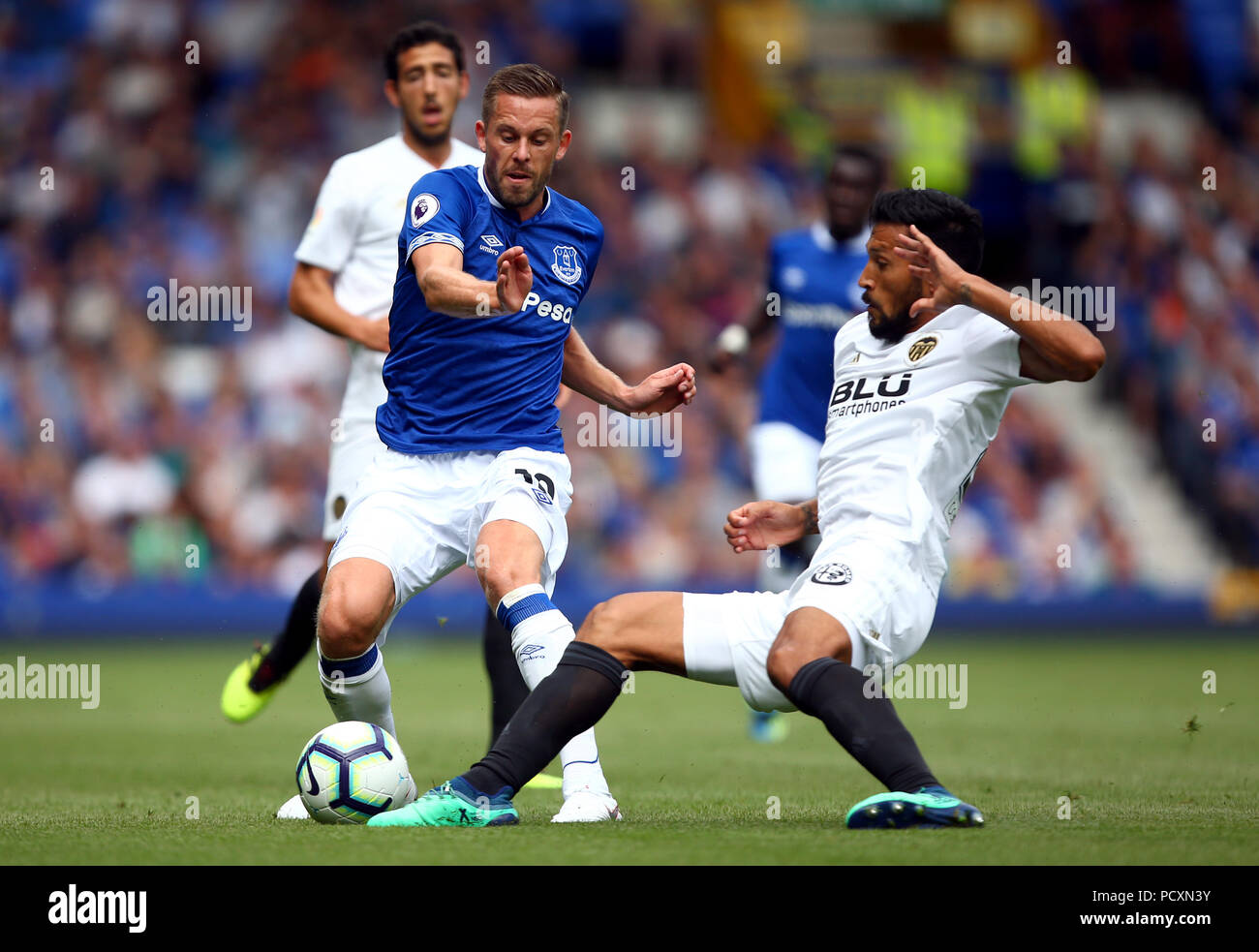 Everton's Gylfi Sigurdsson and Valencia's Ezequiel Garay (right) battle for the ball during the pre-season friendly match at Goodison Park, Liverpool. Stock Photo