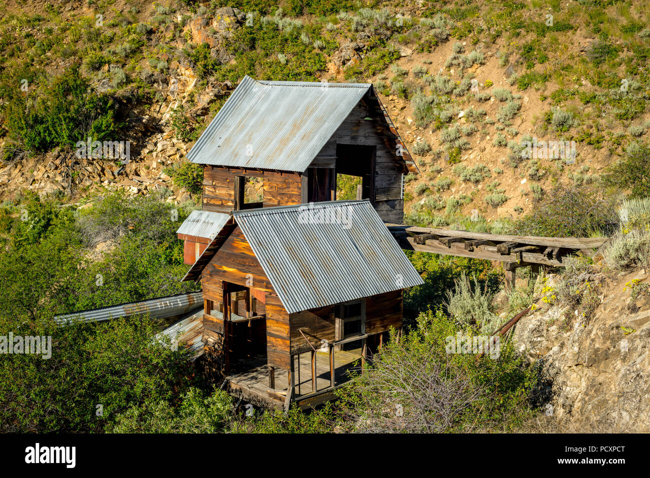 Rustic old abandoned wood mine out building in a desert canyon Stock